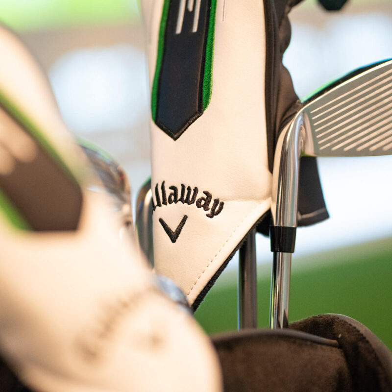 Close-up of Callaway golf club covers and a club head in a golf bag, with soft lighting and a blurred background—perfect inspiration for golf lessons or exploring golf membership options in London.
