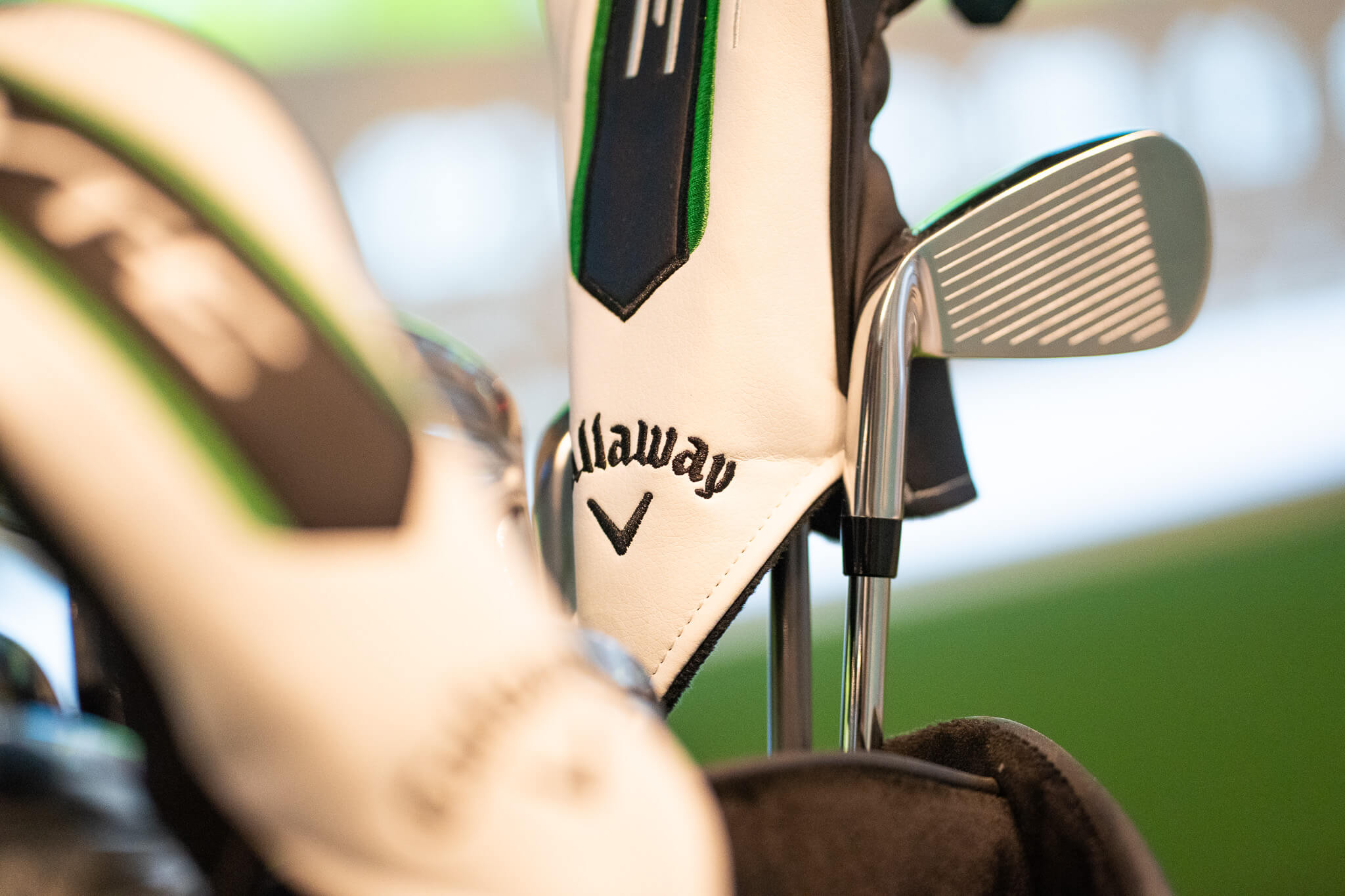 Close-up of Callaway golf club covers and a club head in a golf bag, with soft lighting and a blurred background—perfect inspiration for golf lessons or exploring golf membership options in London.